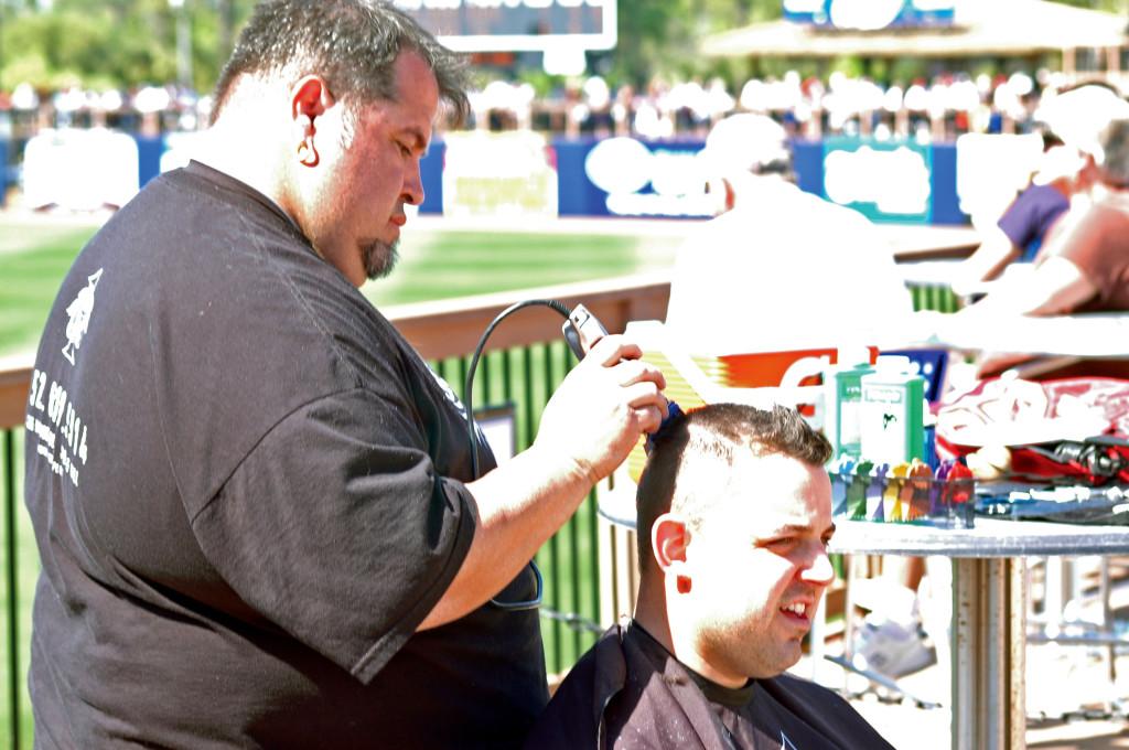 Wilber Bonilla shaving the head of a Rays employee.