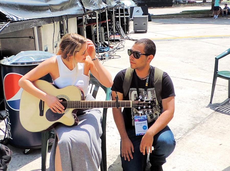 Lia Marie Johnson, backstage, warming up before her performance. 