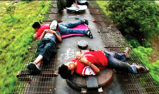 Children resting on top of a train during their journey to America.