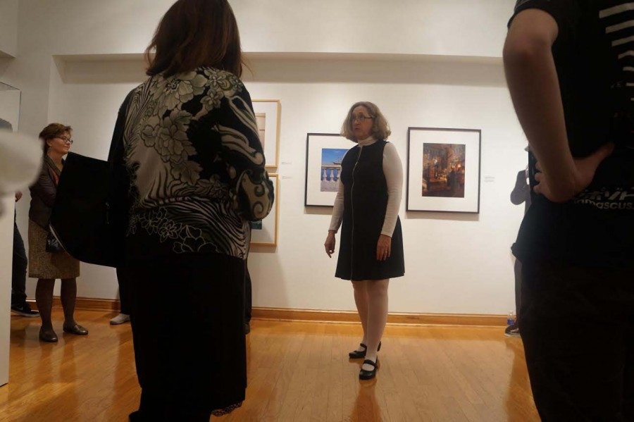 Crosby speaks with visitors at the gallery recepetion. Her current exhibit is "Assembly Required".