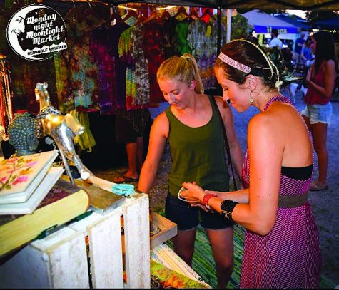 Shoppers get a flavor of the variety of goods at the Moonlight Market.