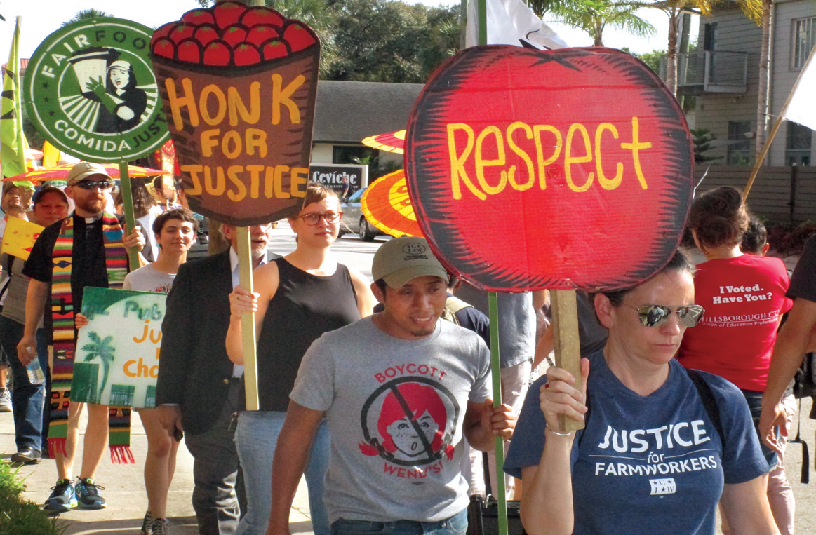 Protester march in front of a Publix in Tampa.