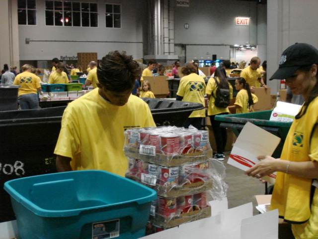 Jena Stansell preparing food kits with other volunteers