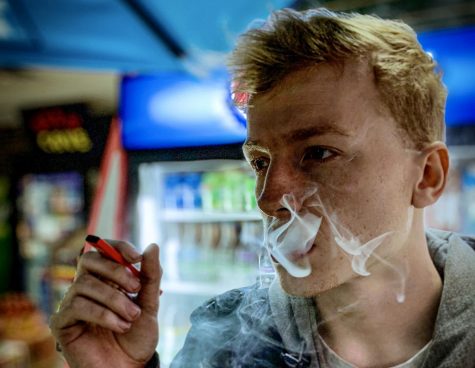 Dalton Cezar, 20,  smoking his vape in a local gas station