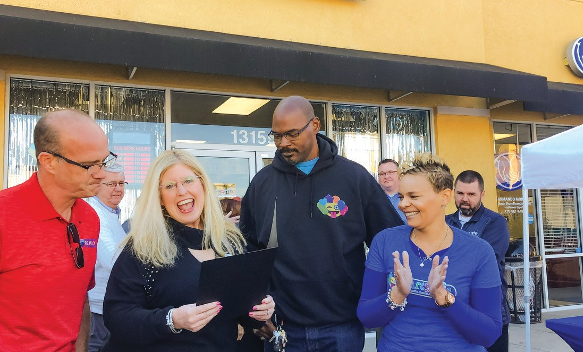 Willie Mae Hansell, John Hansell, Cassandra Hansell and Janeyia Alexander, pose with a certificate and members from Riverview Chamber of Commerce.