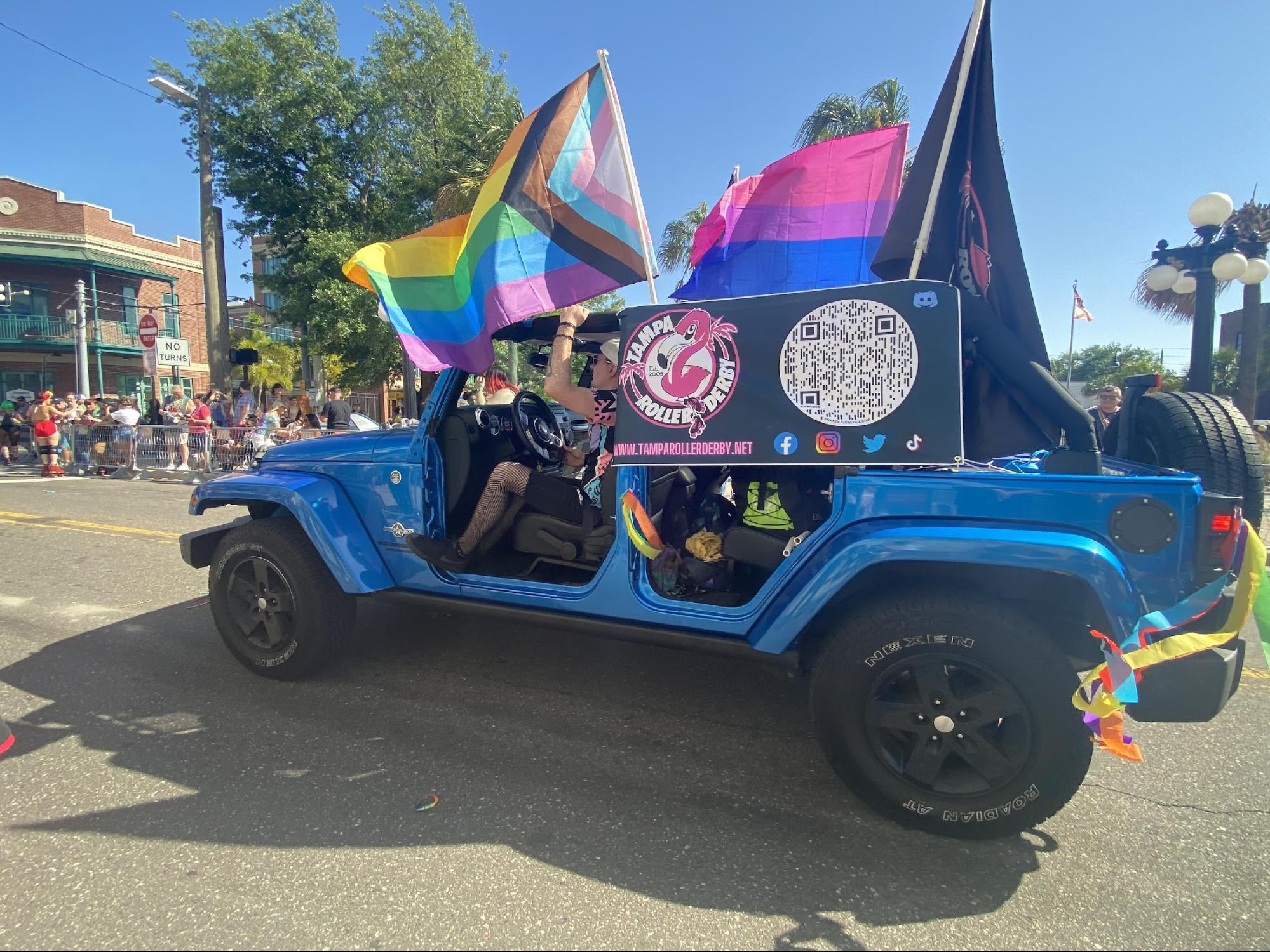 Local teams and businesses drive through the parade in Jeeps and convertibles. Tampa Roller Derby members skated through the parade and threw beads while passing out flyers for their first game.
