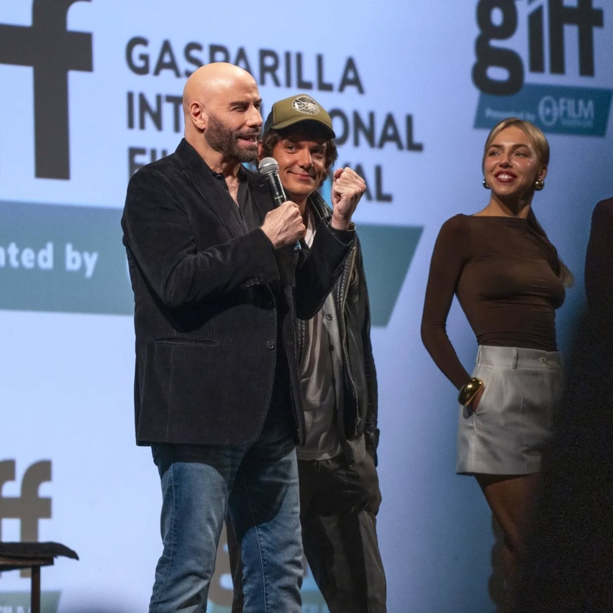 John Travolta introduces his film crew at the closing night premier of High Rollers.