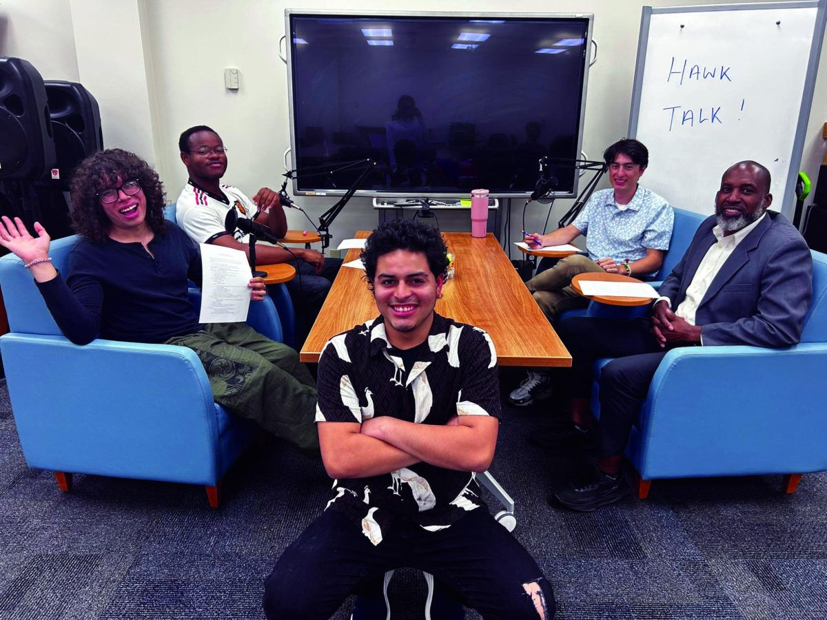 The HCC students of “Hawk Talk” pose with professor and guest Lorenzo Carswell (far right).
